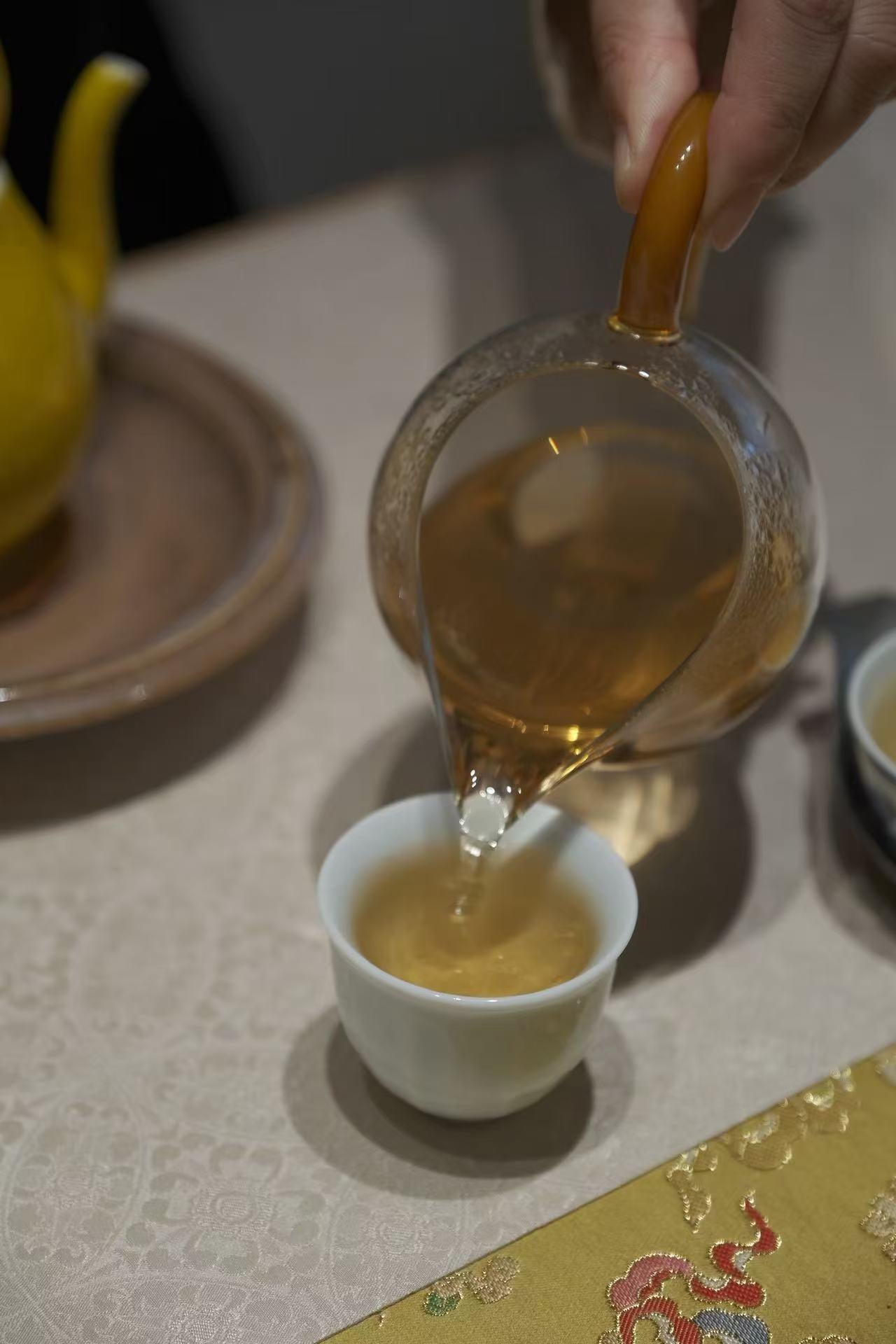 Close view of tea being poured into a cup